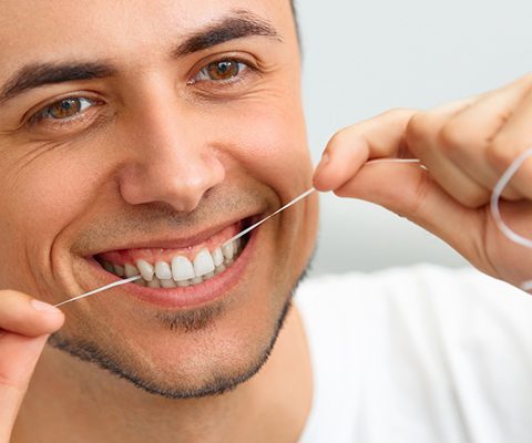 Man flossing teeth