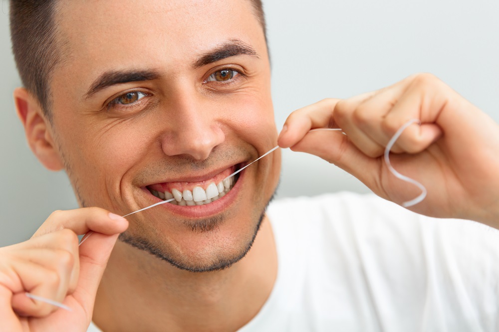 Man flossing teeth