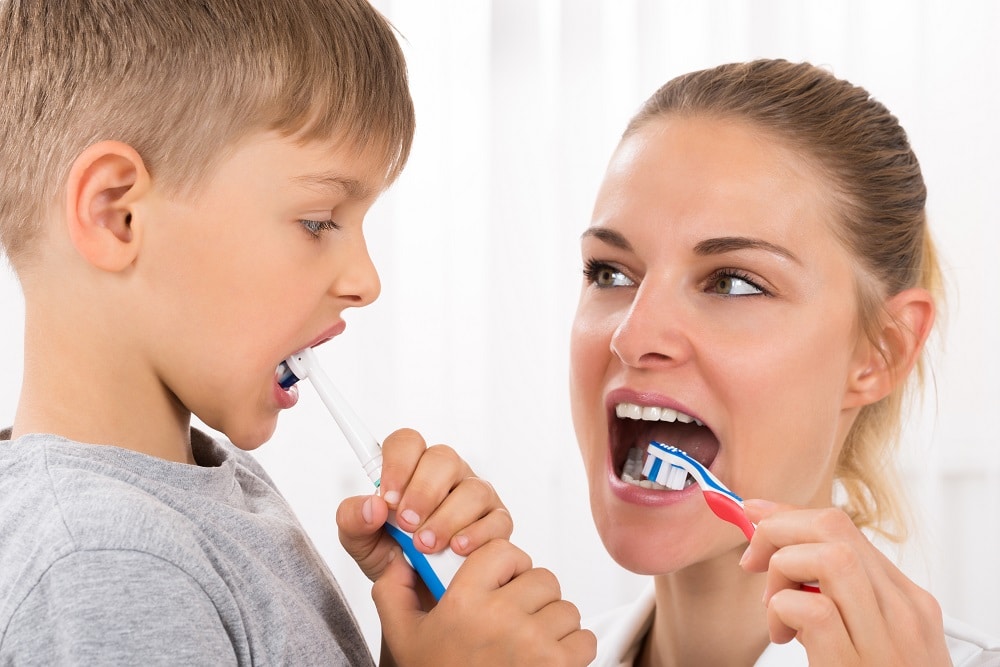 Using a toothbrush with mum