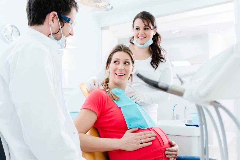 Pregnant woman at dentist before treatment