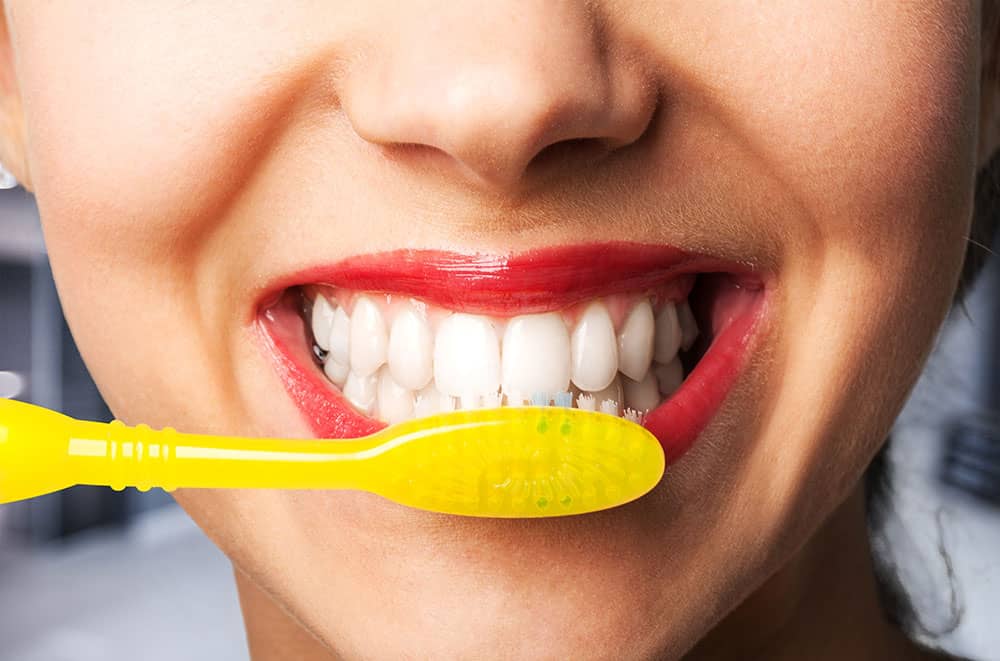 woman brushing teeth