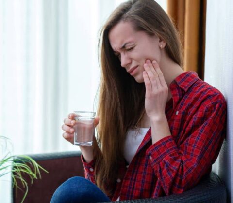 Young woman with mouth sore.