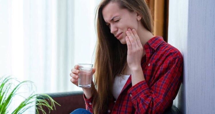 Young woman with mouth sore.