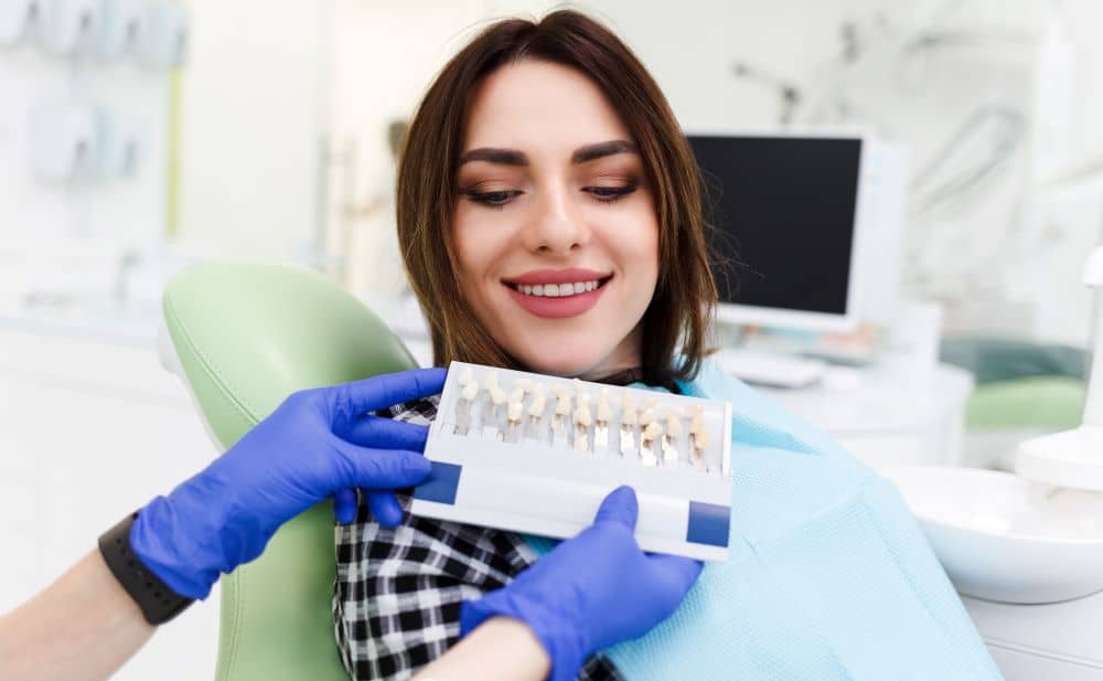 Woman choosing veneer colour.