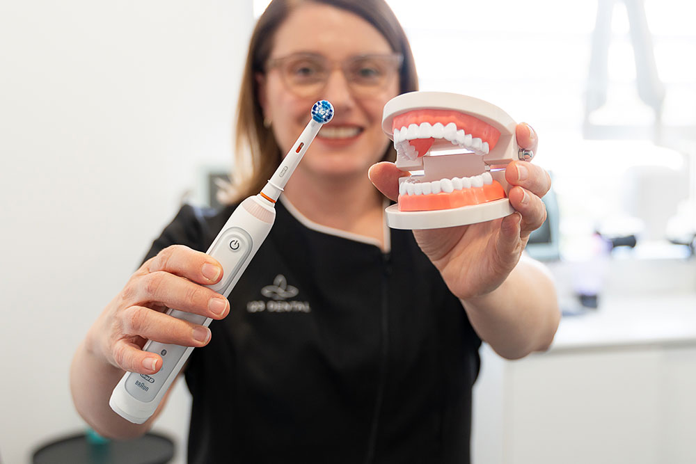 dentist holding up toothbrush