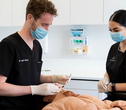 dentist working on patient in chair