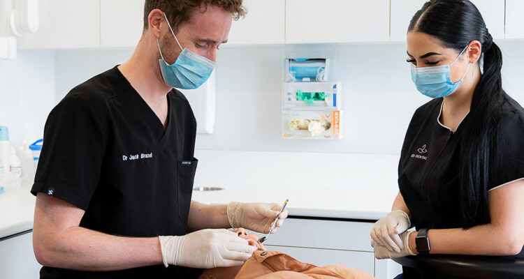 dentist working on patient in chair