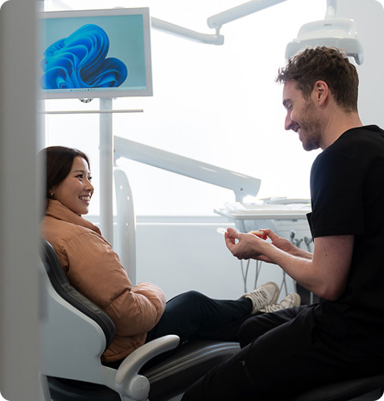 dentist showing how to put Invisalign in