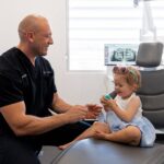 child sitting on dental seat