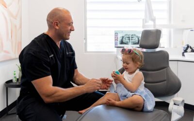 child sitting on dental seat