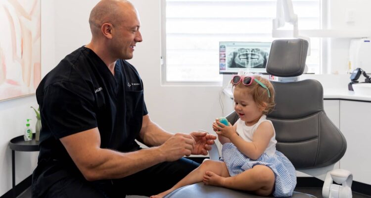 child sitting on dental seat