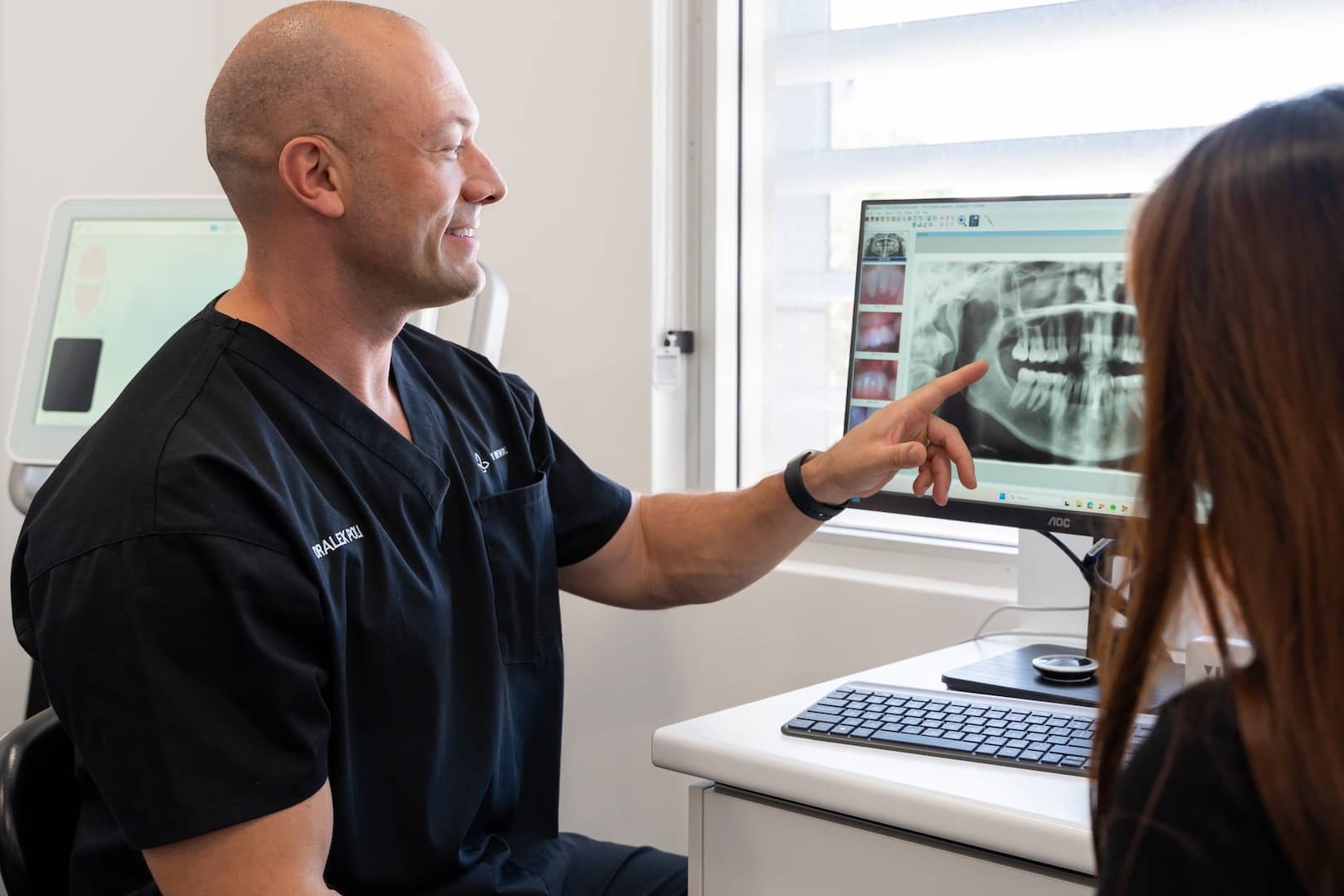 dentist pointing at implant x ray