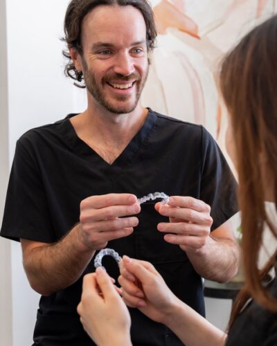 invisalign-cosmetic dentist showing Invisalign to patient