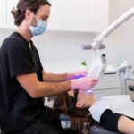 dentist doing professional teeth whitening
