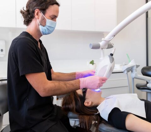 dentist doing professional teeth whitening