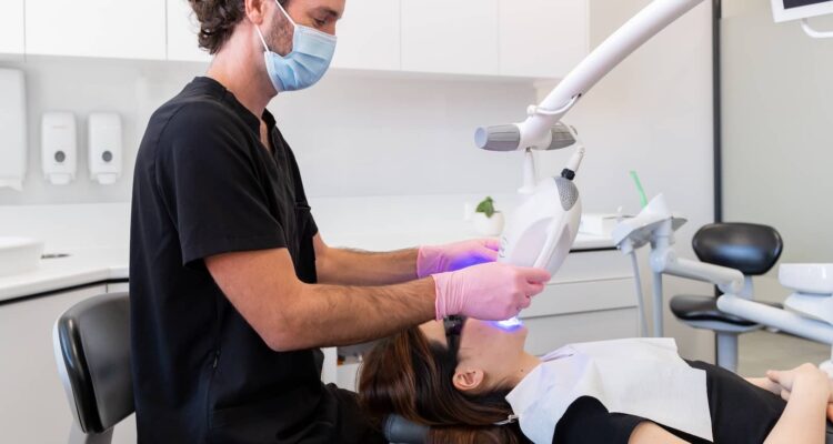 dentist doing professional teeth whitening