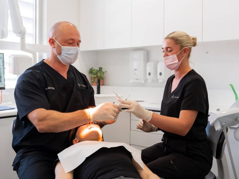 dental-scale-clean Dentist and dental assistant performing a professional scale and clean to remove plaque and tartar in a Perth dental clinic