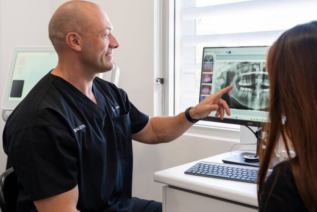 dentist pointing at implant x ray